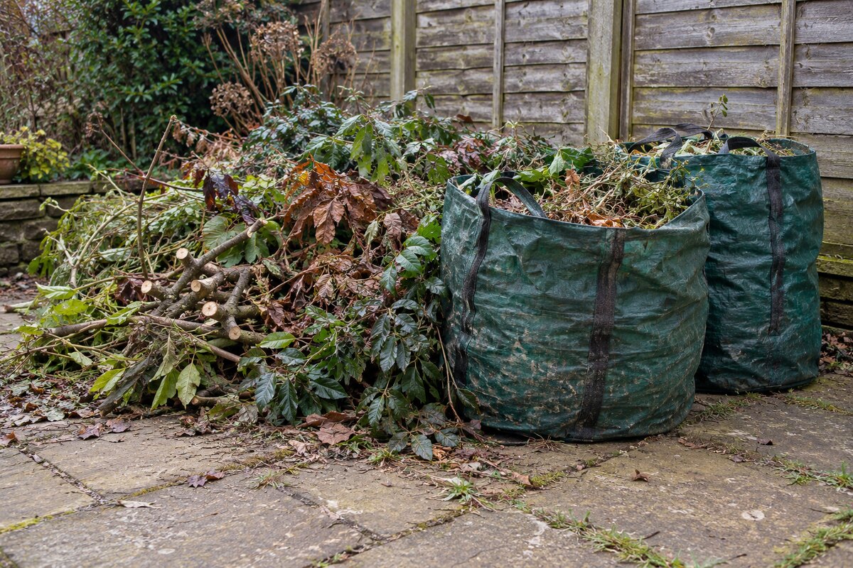 Branches, hedge cuttings and garden sacks of leaves awaiting collection